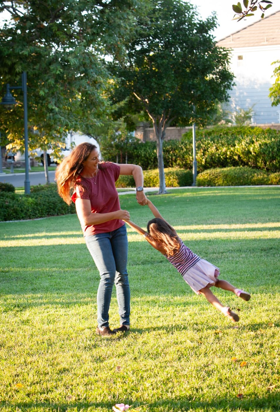 A resident playing with her daughter on a Columbus Grove greenbelt