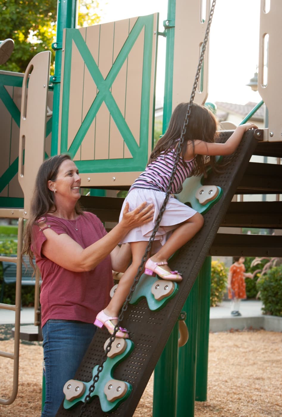 A child climbing at a Columbus Grove community playground